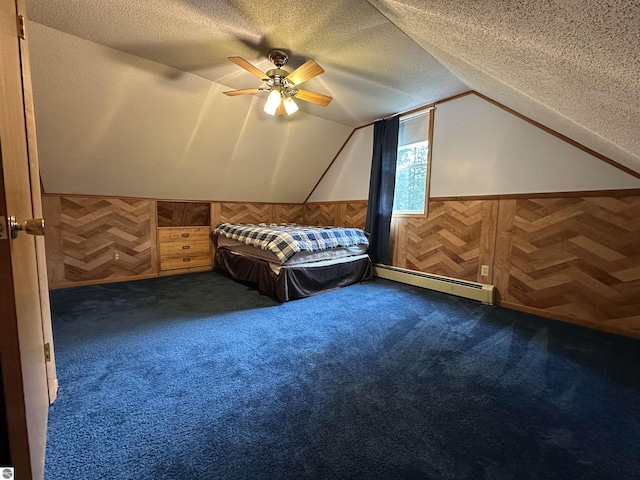 bedroom with a baseboard radiator, a textured ceiling, vaulted ceiling, dark colored carpet, and wainscoting
