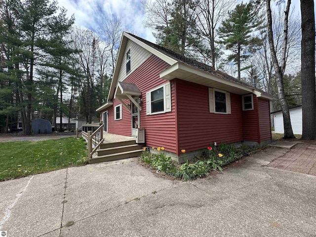 view of side of home with a lawn