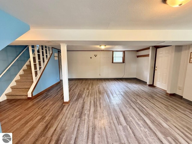 1411 N Dr, Mount Pleasant, MI 48858 - below grade area with stairs, baseboards, and wood finished floors