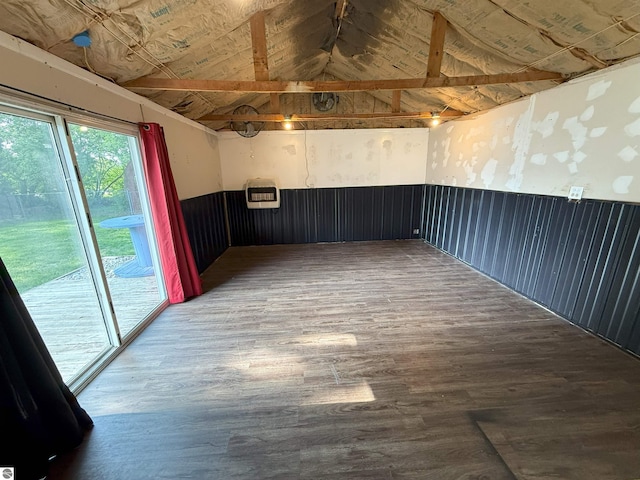 1411 N Dr, Mount Pleasant, MI 48858 - empty room with lofted ceiling, wood finished floors, heating unit, and wainscoting