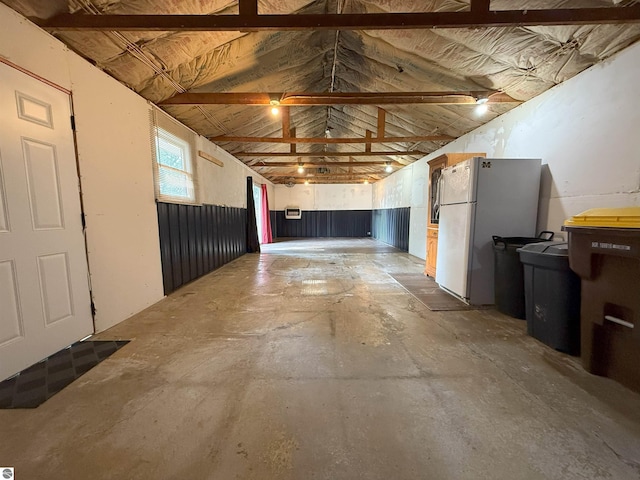 1411 N Dr, Mount Pleasant, MI 48858 - misc room with unfinished concrete flooring, lofted ceiling, and a garage