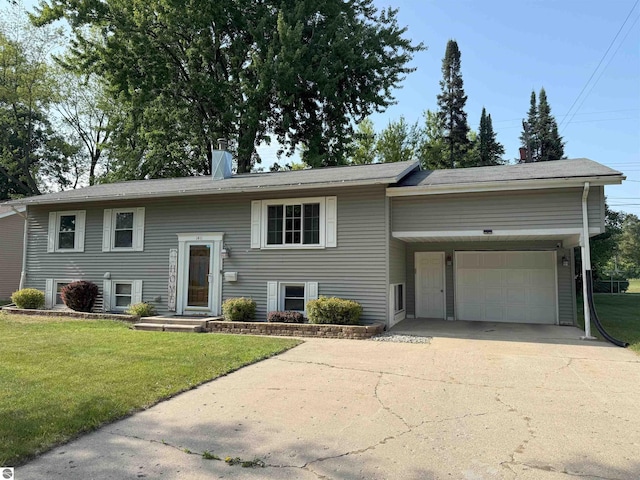 1411 N Dr, Mount Pleasant, MI 48858 - bi-level home with a front lawn, driveway, and an attached garage