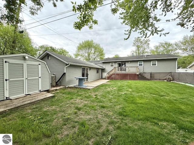 1411 N Dr, Mount Pleasant, MI 48858 - rear view of property with a storage shed, a deck, and an outdoor structure