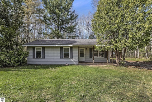 7401 Red Maple Dr, Cadillac, MI 49601 - view of front facade with covered porch, a front lawn, and roof with shingles