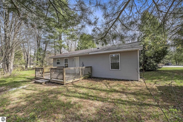 7401 Red Maple Dr, Cadillac, MI 49601 - rear view of property featuring a wooden deck and a lawn