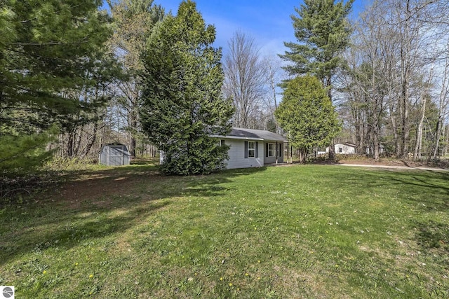 7401 Red Maple Dr, Cadillac, MI 49601 - view of grassy yard with a shed and an outdoor structure