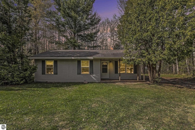 7401 Red Maple Dr, Cadillac, MI 49601 - view of front of house with covered porch and a front lawn