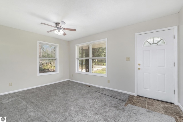 7401 Red Maple Dr, Cadillac, MI 49601 - entrance foyer featuring carpet floors, plenty of natural light, a ceiling fan, and baseboards