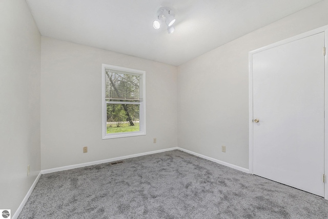 7401 Red Maple Dr, Cadillac, MI 49601 - empty room featuring carpet and baseboards