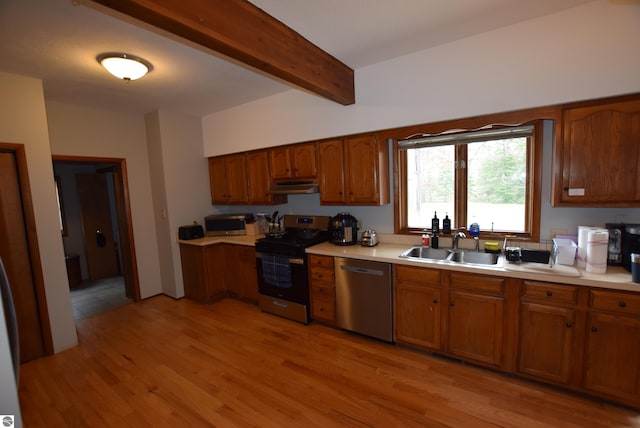 kitchen with stainless steel appliances, under cabinet range hood, a sink, beam ceiling, and light countertops
