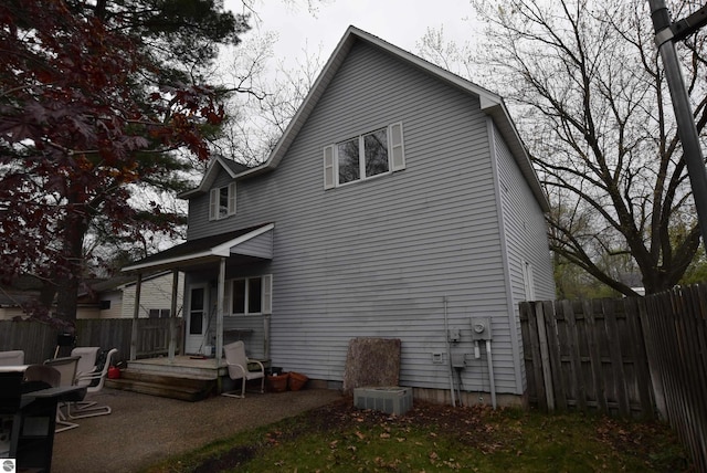rear view of property with fence and a patio area