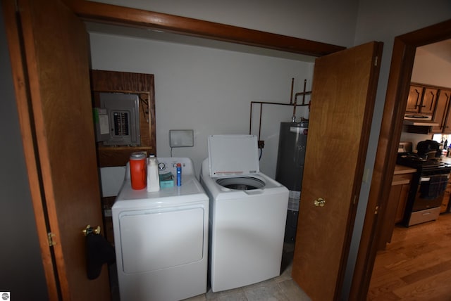 laundry area with washer and dryer, electric panel, and water heater