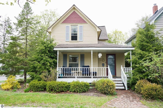 view of front of house featuring a porch and roof with shingles