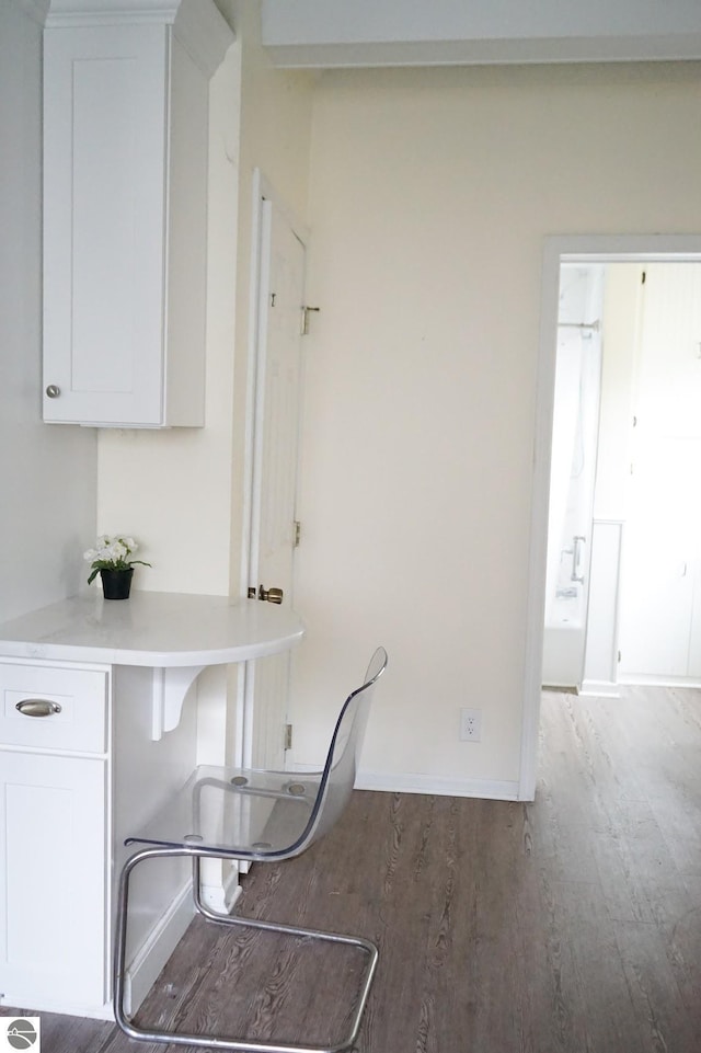 dining space with wood finished floors and baseboards