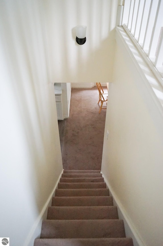 stairway with carpet and baseboards