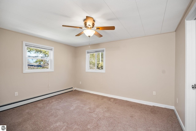 9869 E Cherry Bend Rd, Traverse City, MI 49684 - unfurnished room featuring a baseboard radiator, carpet flooring, ceiling fan, and plenty of natural light
