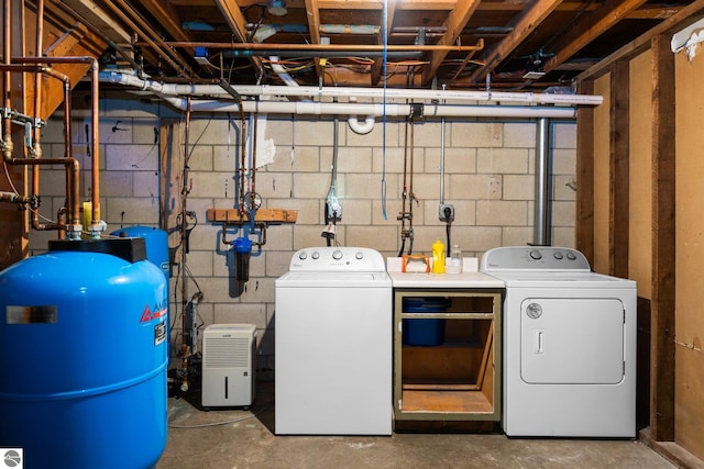 9869 E Cherry Bend Rd, Traverse City, MI 49684 - laundry room featuring washer and clothes dryer and concrete block wall
