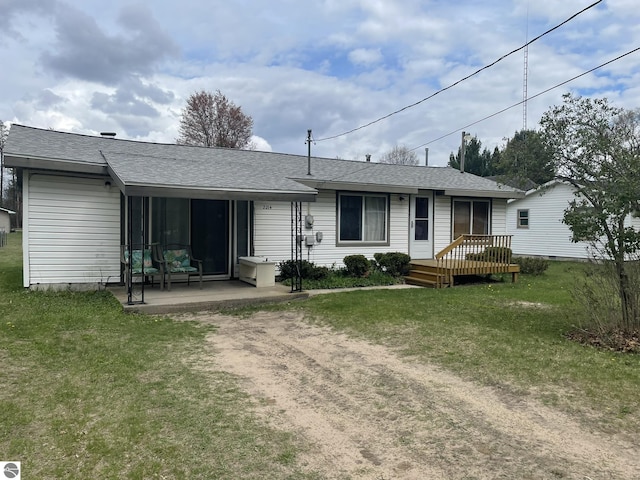 2214 Karen Dr, Saint Helen, MI 48656 - rear view of property featuring a yard, a wooden deck, a patio area, and a shingled roof