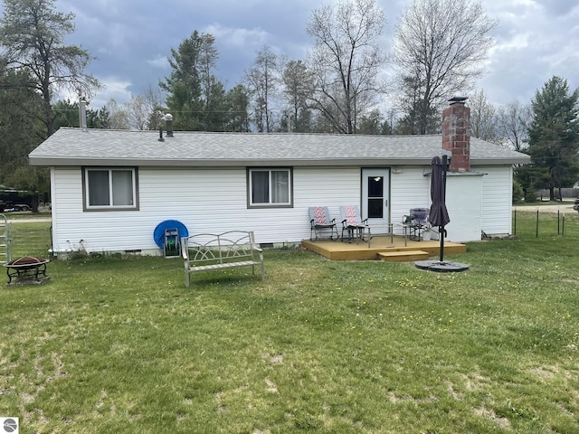 2214 Karen Dr, Saint Helen, MI 48656 - back of property featuring a wooden deck, a shingled roof, a fire pit, a chimney, and crawl space