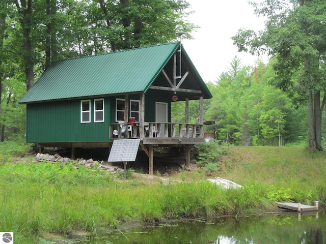00 S 47 3/4 Rd, Cadillac, MI 49601 - view of front of property featuring metal roof and a deck with water view