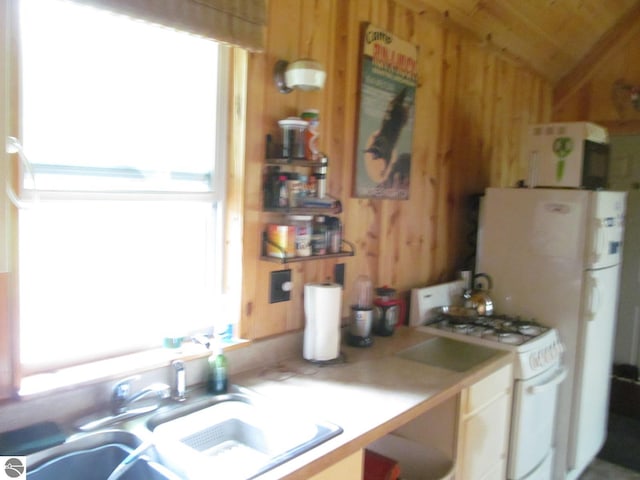 00 S 47 3/4 Rd, Cadillac, MI 49601 - kitchen featuring gas range gas stove, wooden walls, vaulted ceiling, light countertops, and a sink