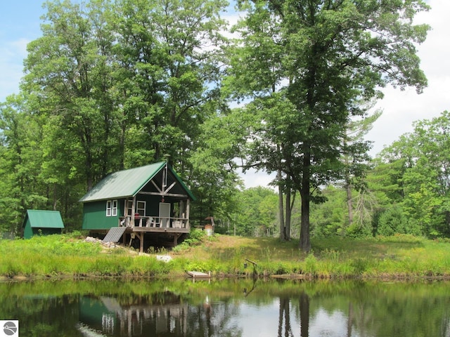 00 S 47 3/4 Rd, Cadillac, MI 49601 - back of property featuring a water view, metal roof, and a view of trees