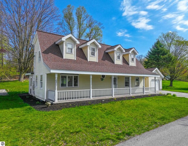 8377 Zosel St, Onekama, MI 49675 - view of front of property featuring a porch, a front yard, and driveway