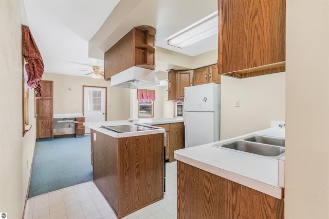 8377 Zosel St, Onekama, MI 49675 - kitchen featuring freestanding refrigerator, a sink, brown cabinetry, ceiling fan, and electric cooktop