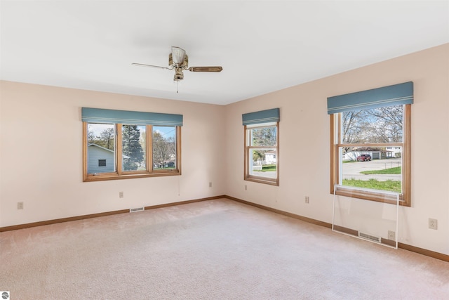 8377 Zosel St, Onekama, MI 49675 - empty room featuring ceiling fan, light carpet, and baseboards