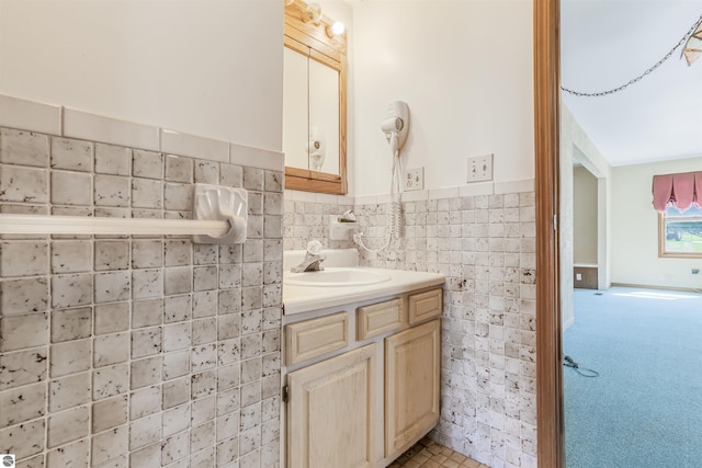 8377 Zosel St, Onekama, MI 49675 - bathroom with tile walls, a wainscoted wall, and vanity