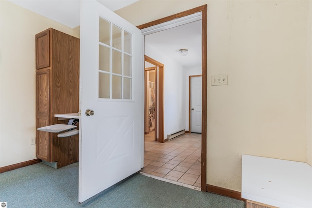 8377 Zosel St, Onekama, MI 49675 - hallway with baseboard heating, light colored carpet, and baseboards