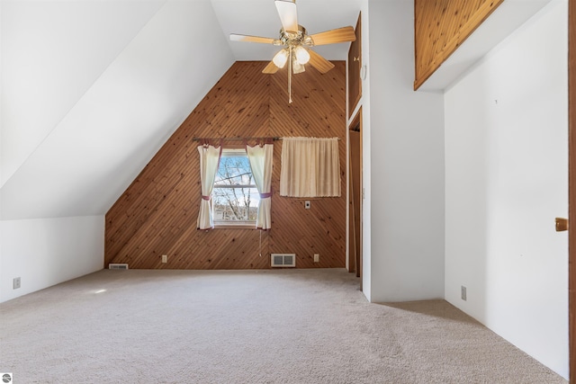 8377 Zosel St, Onekama, MI 49675 - additional living space with wood walls, carpet, ceiling fan, and lofted ceiling