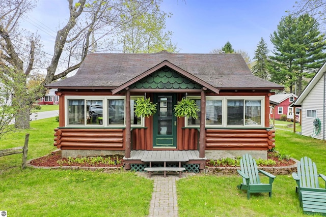 66 N Center St, Lake City, MI 49651 - view of front of home featuring a front yard and log exterior