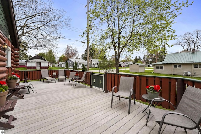 66 N Center St, Lake City, MI 49651 - wooden deck featuring a residential view, a storage shed, and an outbuilding