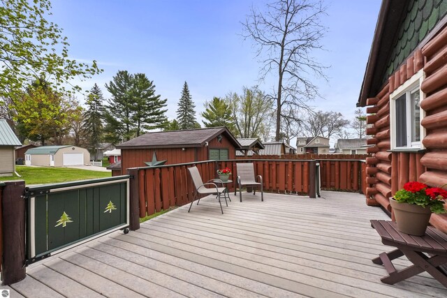 66 N Center St, Lake City, MI 49651 - wooden terrace with an outdoor structure, a storage unit, and a residential view
