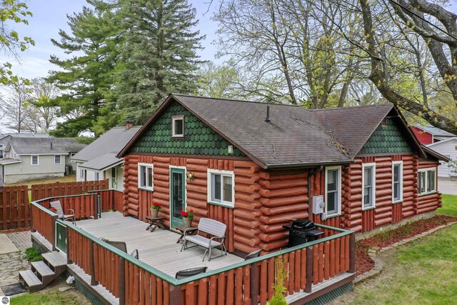 66 N Center St, Lake City, MI 49651 - rear view of property featuring log exterior and a deck