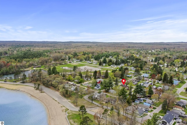 66 N Center St, Lake City, MI 49651 - aerial view of property and surrounding area with a nearby body of water, nearby suburban area, and a heavily wooded area