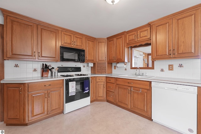 8805 Iroquois Trl, Saint Helen, MI 48656 - kitchen with white appliances, a sink, and brown cabinets