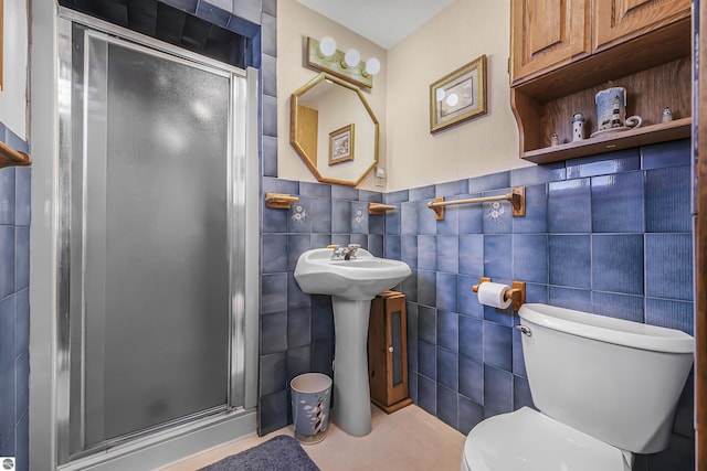 8805 Iroquois Trl, Saint Helen, MI 48656 - bathroom featuring a stall shower, toilet, tile walls, and a sink