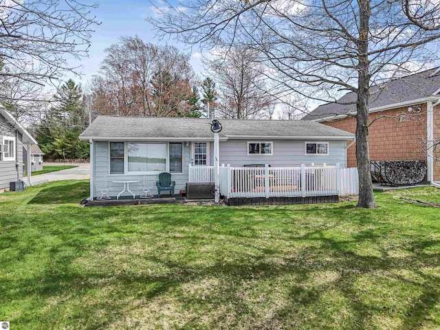 8805 Iroquois Trl, Saint Helen, MI 48656 - rear view of house with a lawn and a shingled roof