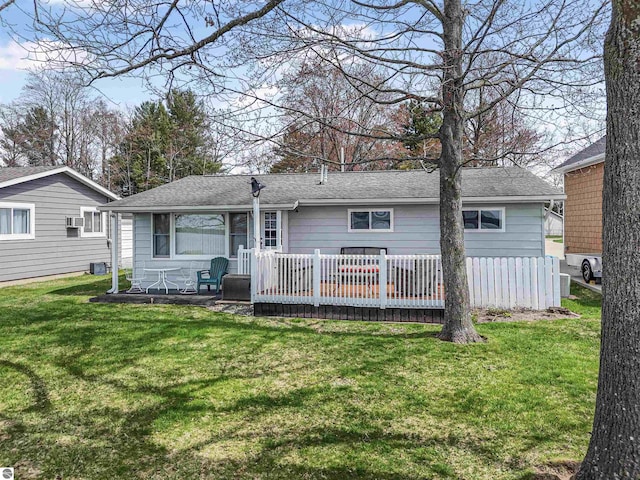 8805 Iroquois Trl, Saint Helen, MI 48656 - back of property with a lawn, a wooden deck, and a shingled roof