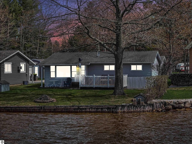 8805 Iroquois Trl, Saint Helen, MI 48656 - back of property with a water view, an outdoor fire pit, and a yard
