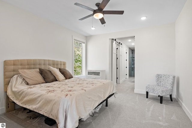 3046 E Greenwood Rd, Lake Leelanau, MI 49653 - bedroom with light carpet, baseboards, recessed lighting, ceiling fan, and a barn door