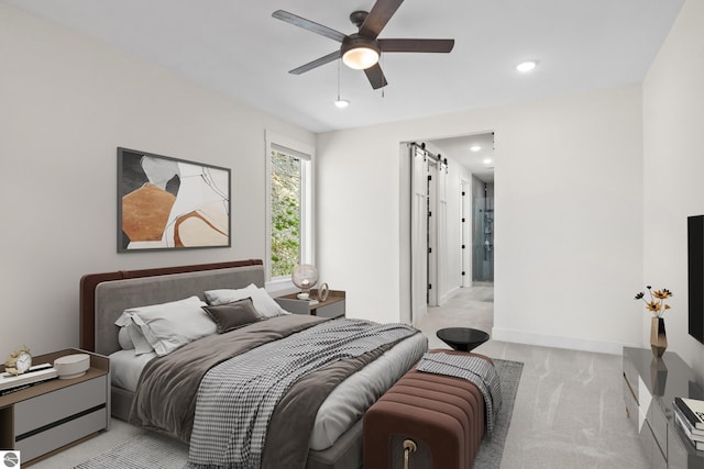 3046 E Greenwood Rd, Lake Leelanau, MI 49653 - bedroom featuring light colored carpet, recessed lighting, baseboards, a ceiling fan, and a barn door