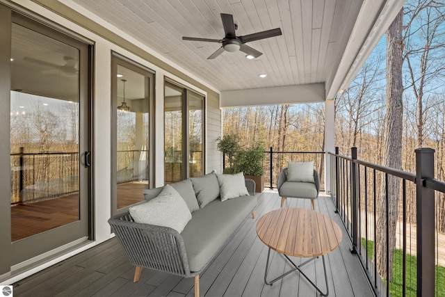 3046 E Greenwood Rd, Lake Leelanau, MI 49653 - wooden deck with ceiling fan and an outdoor hangout area