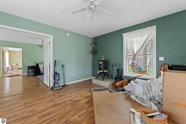 512 NW Kalkaska St, Kalkaska, MI 49646 - living room featuring wood finished floors, a ceiling fan, and baseboards