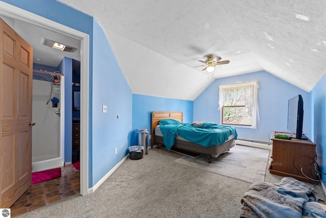 512 NW Kalkaska St, Kalkaska, MI 49646 - carpeted bedroom featuring lofted ceiling, baseboards, baseboard heating, ceiling fan, and a textured ceiling