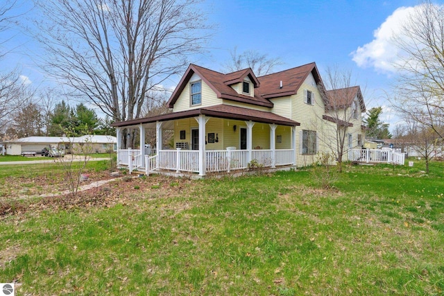 512 NW Kalkaska St, Kalkaska, MI 49646 - view of side of home featuring a porch and a lawn
