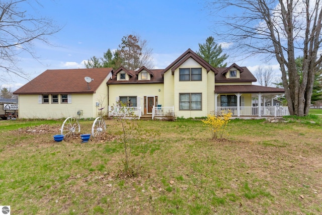512 NW Kalkaska St, Kalkaska, MI 49646 - rear view of property with a yard and a porch