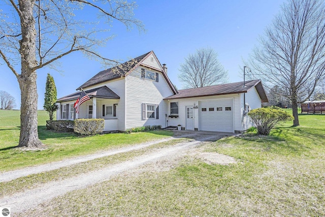 view of front of house with dirt driveway, an attached garage, and a front yard